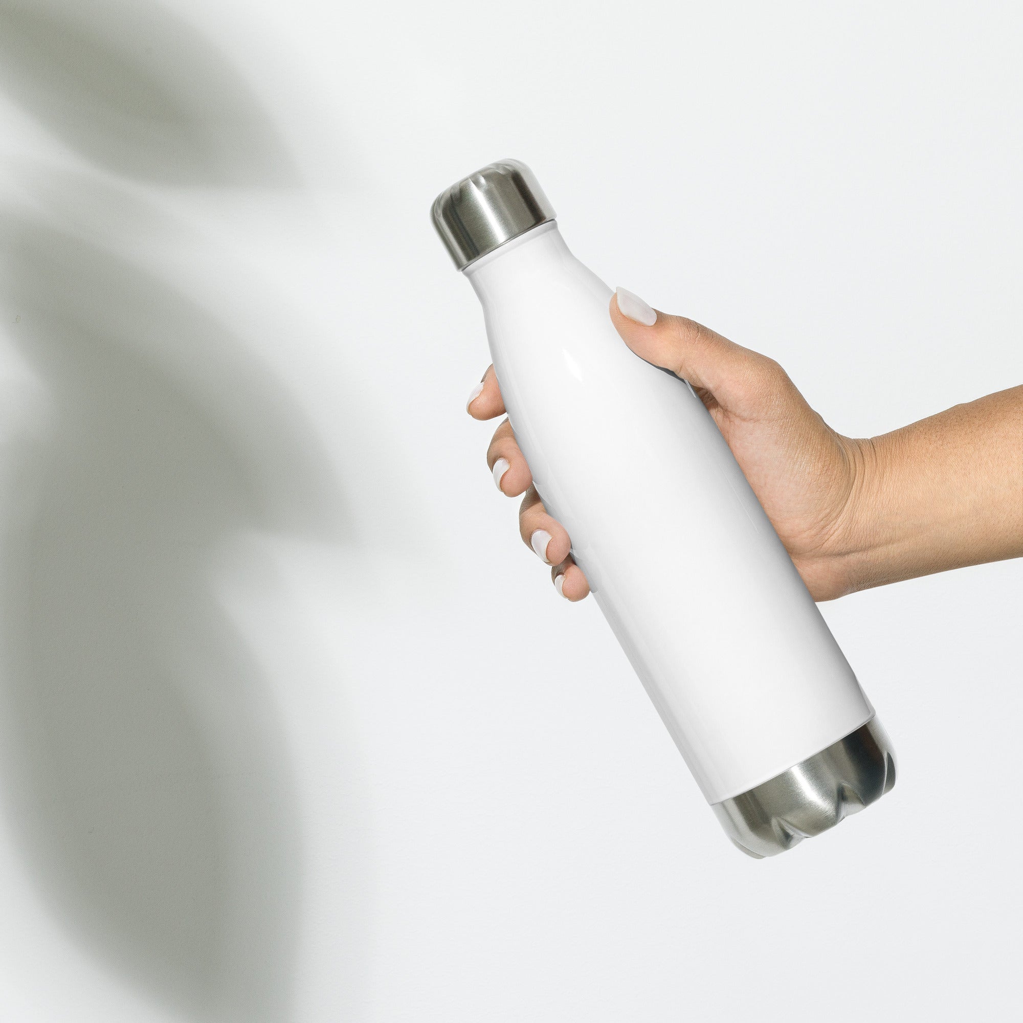 Stainless steel water bottle from SCD One with a hand holding the water bottle showiing the back side second alternate view