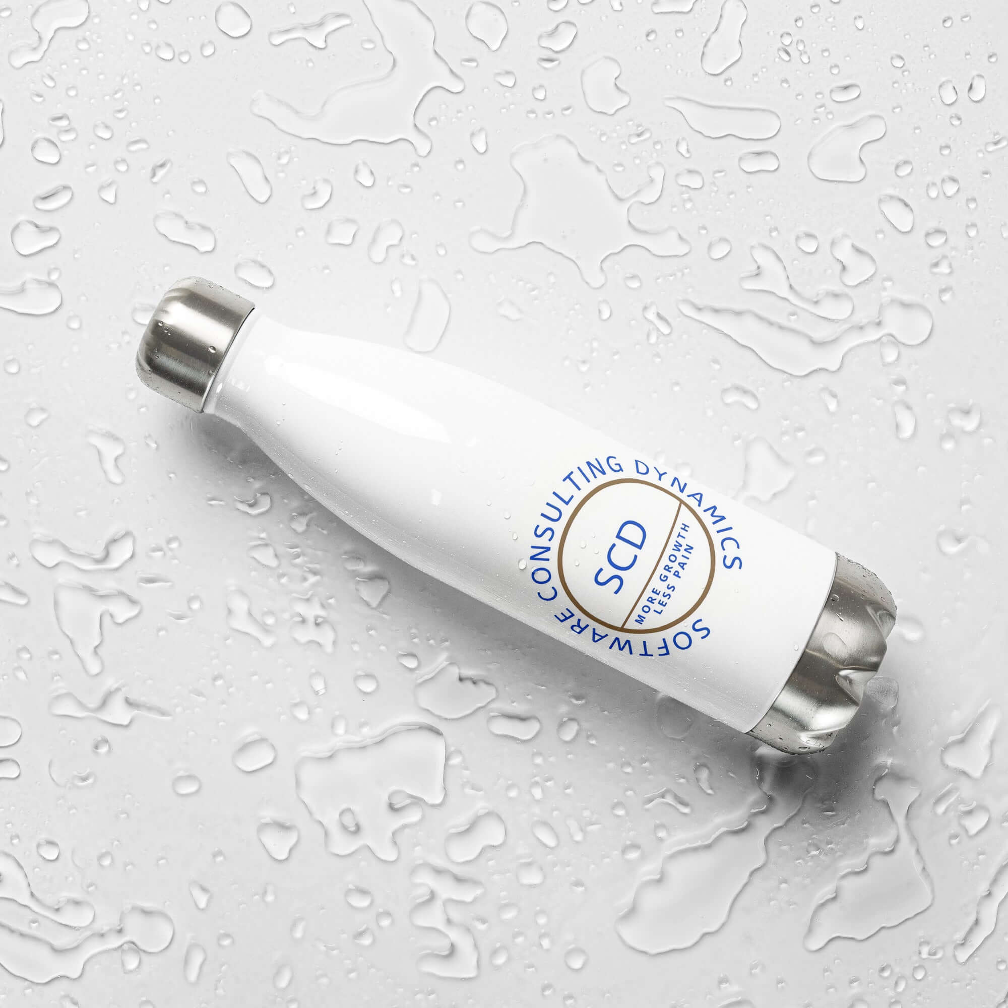 Stainless steel water bottle from SCD One laying on a flat surface with a left tilt