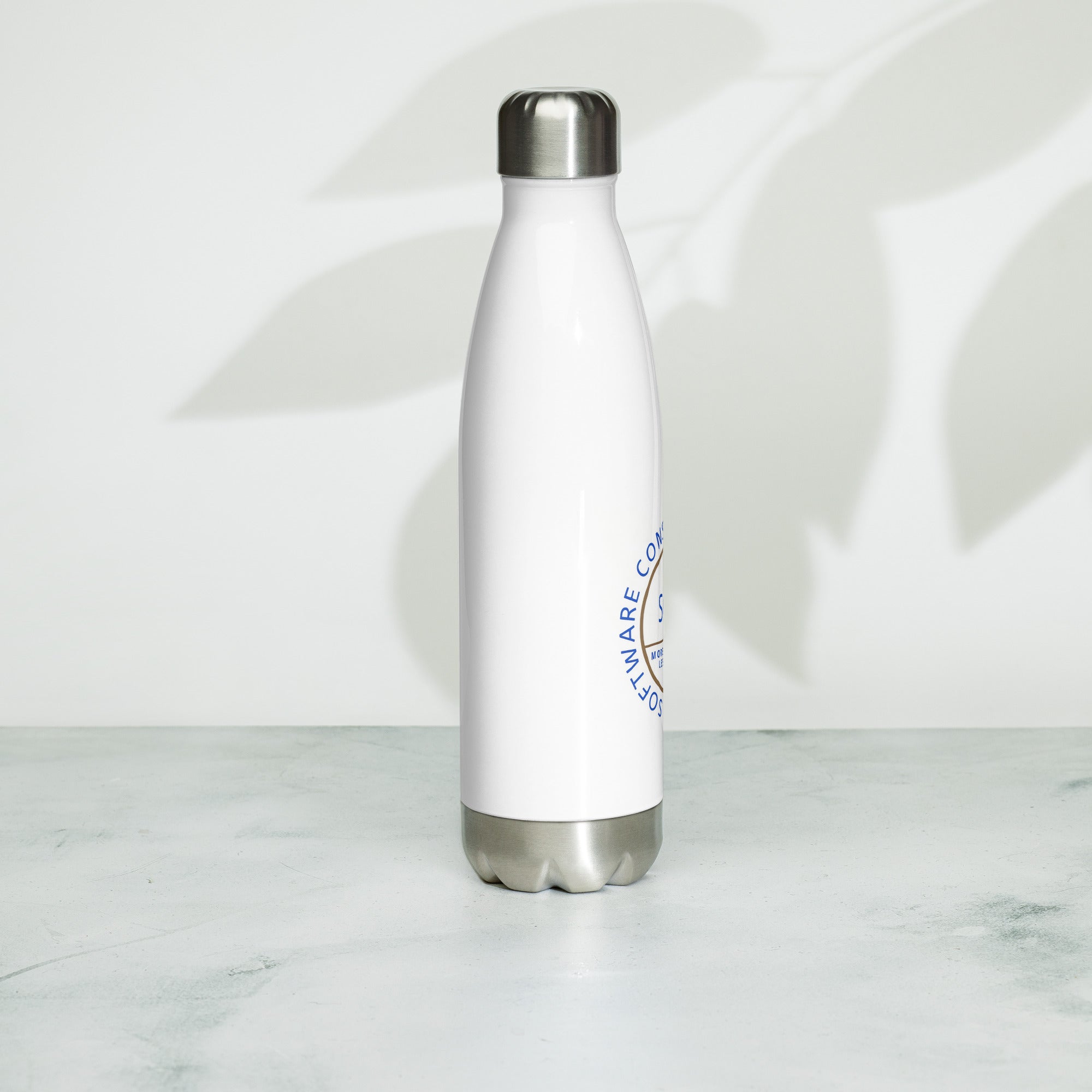 Stainless steel water bottle from SCD One resting on a flat surface sitting upright showing the  design free back side alternate view